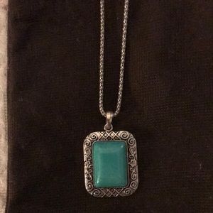 Turquoise and silver pendant on a 16” silver chain.